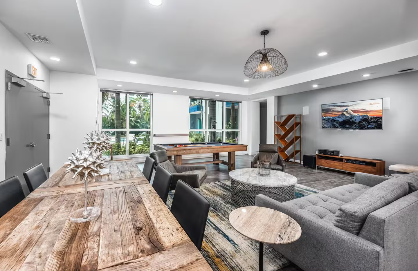 Community game room with pool table and lounge seating